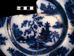 Printed flow blue underglaze refined white earthenware plate with a Chinoiserie landscape motif pattern.Chapoo maker's mark on right. John Wedge Wood, Burslem 1845-1860, from 18BC27, Feature 28.